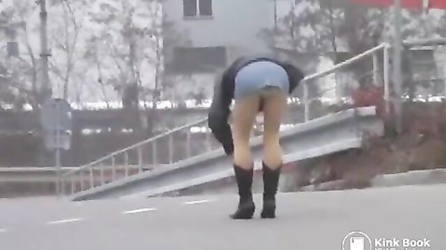 Blonde in pantyhose & boots bends over, poops publicly in cold street
