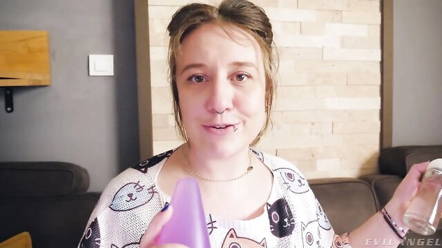 Proxy Paige holds purple dildo and water bottle in cat shirt, EvilAngel