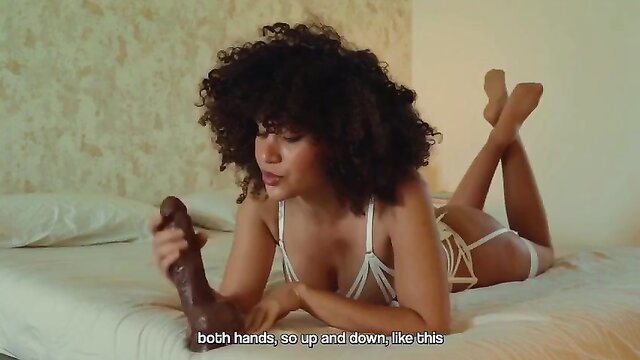 Curly-haired black babe in lingerie strokes big black dildo JOI