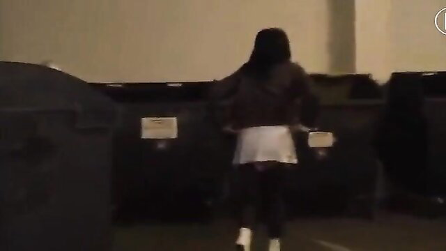 Asian woman in mini skirt and heels by dumpsters, diaper fetish tease