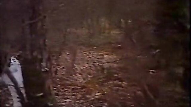 Vintage 1984 trans outdoor forest scene, nude figure bent over