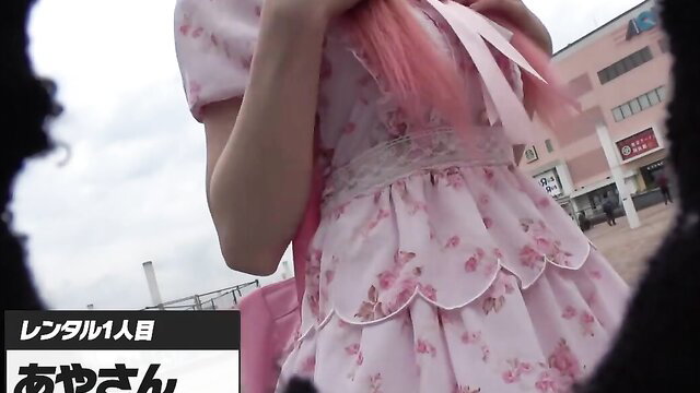 Pink-haired Japanese neo unemployed woman in frilly lolita dress outside