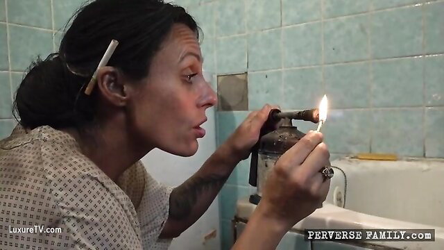 Tattooed brunette lighting crack pipe in bathroom, Perverse Family 1 Part 8