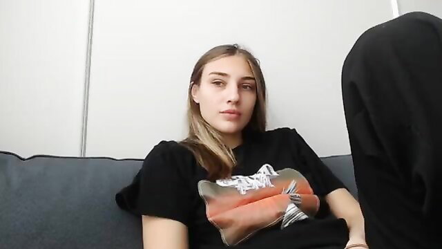 TastyBrunette on couch in black tee, young brunette beauty teases