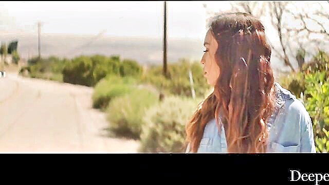 Kelsi Monroe hippy in denim shirt, outdoors profile view