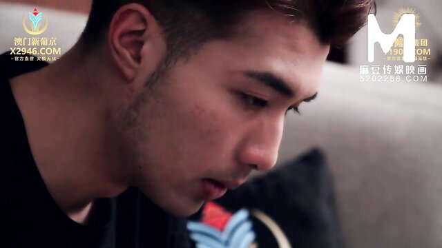 Handsome Asian man with undercut hair in black shirt, closeup profile view