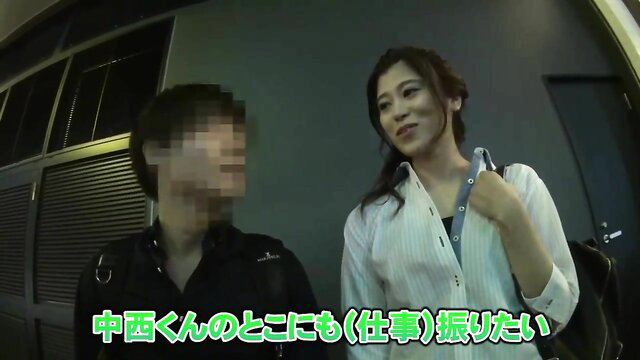 Japanese couple in parking garage, smiling woman with ponytail and blouse