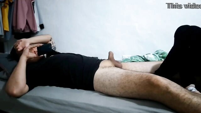 Hairy Asian guy lying nude on bed exposing flaccid cock in amateur solo