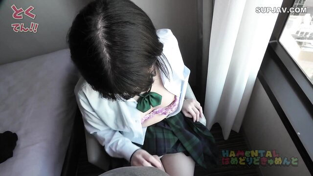 Japanese schoolgirl in plaid skirt and open blouse teases upskirt on sofa