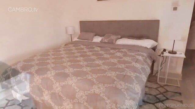 Cozy bedroom with gray patterned duvet on king bed, side tables and lamps