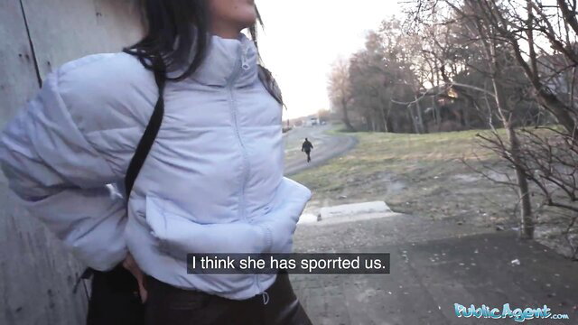 Asian brunette in white puffer jacket suspects spotting in public park