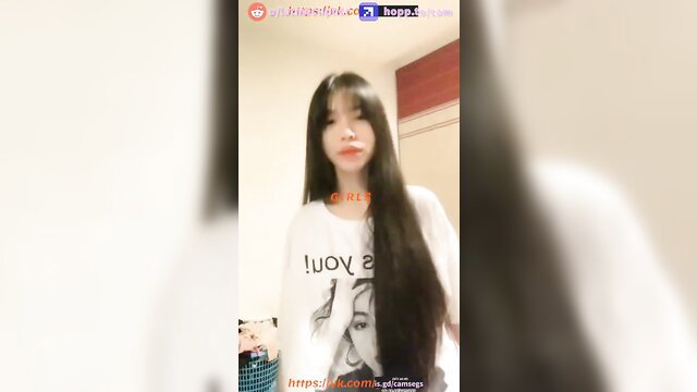 Asian beauty in oversized white tee, long black hair, cute smile closeup