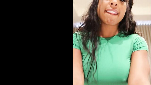 Qimmah in tight green top smirking cleavage tease