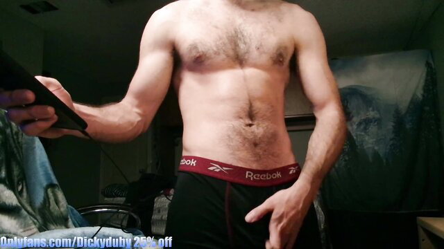 Hairy muscular guy in tight Reebok briefs teases big bulge solo
