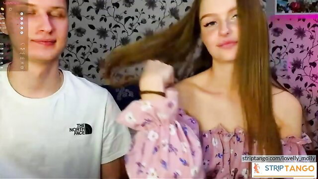 Amateur teen beauty with long hair posing with guy in pink off-shoulder dress