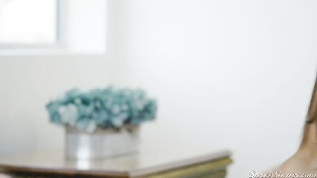 Sexy cougar in elegant room with blue hydrangea flower vase