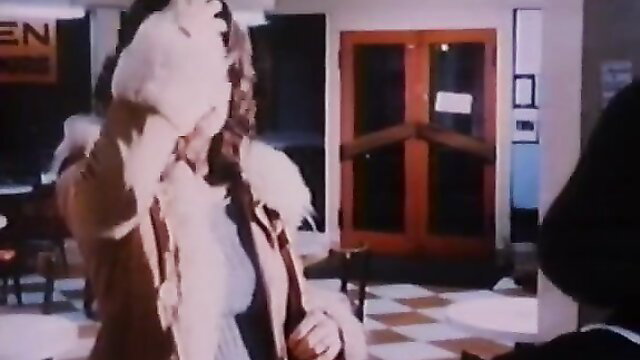 Vintage 1976 porn star in fur coat and white top at Easy Alice