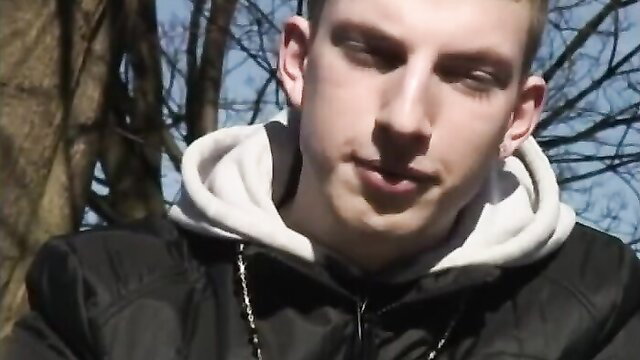 Young English lad in hoodie smirking outdoors, amateur gay thumbnail