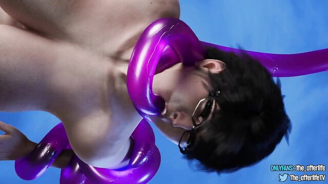 Bayonetta cosplay guy bound by purple floaties, nude, upside down tease