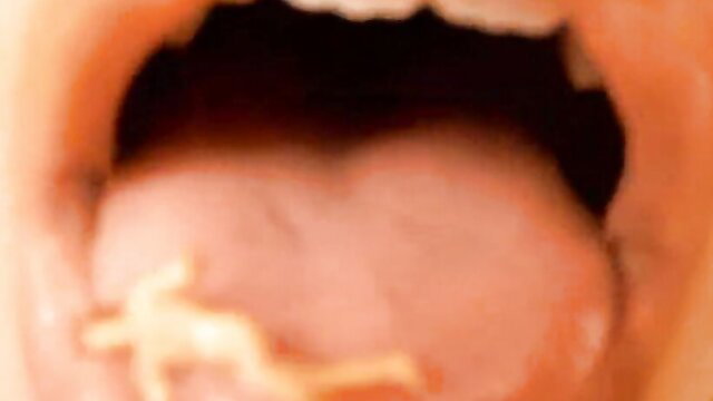 Close-up of brunette's wet tongue and mouth in erotic tease