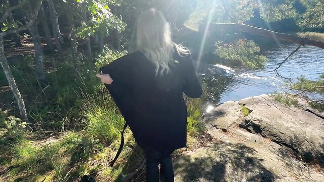 Uwucutedemon Swedish blonde in black coat at sunny forest stream