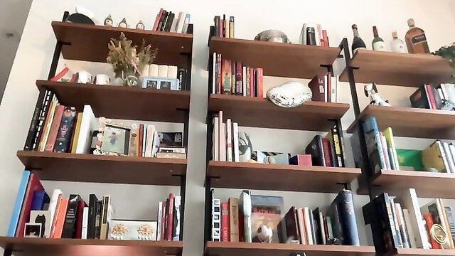 Mia Khalifa's cozy bookshelf with books and decor