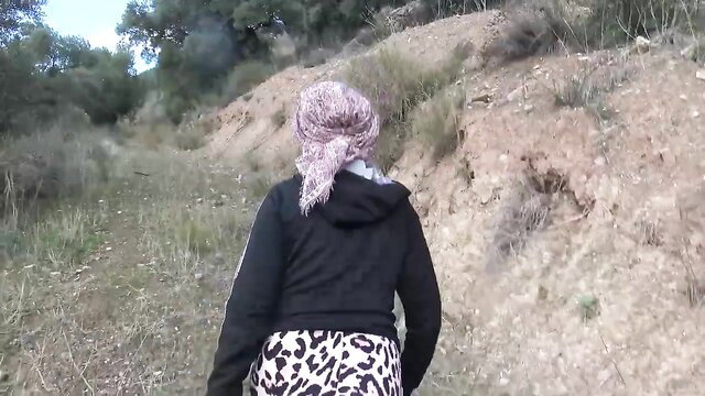 Souzan Halabi mature amateur walking in leopard pants and hijab outdoors
