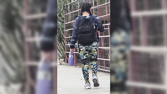 Latina walking away in tight camo leggings showing huge round ass