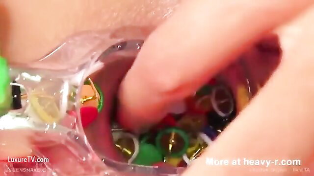 Tanita from Queensnake stuffs colorful tacks into her vagina closeup
