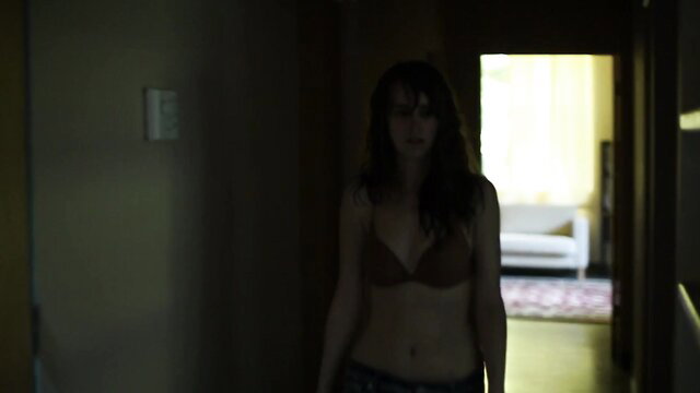 Joslyn Jensen in sexy bra, topless tease in dim hallway from Without (2011)