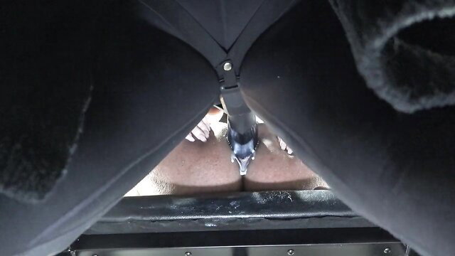 POV closeup of woman's wet pussy spread by belt strap on taut anus