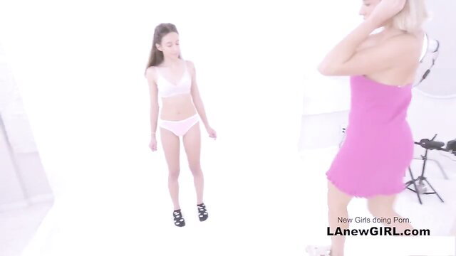 Young Asian girl in pink lingerie posing with aroused blonde in dress