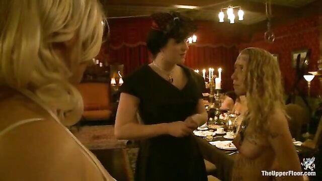 Blonde slave girl nude at dinner table with sadistic dressed ladies