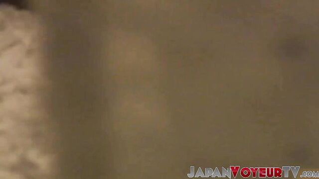 Voyeur zooms on Asian babe in bed fingering to loud orgasms
