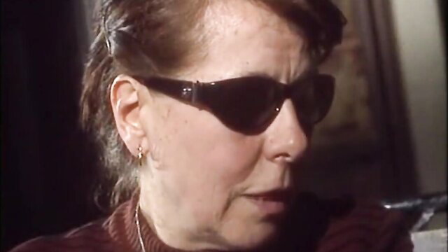 Karen Lancaume in dark sunglasses smirking, Morbid Tales 1998