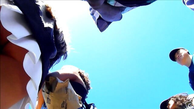 Upskirt group of beauties' asses and panties exposed outdoors