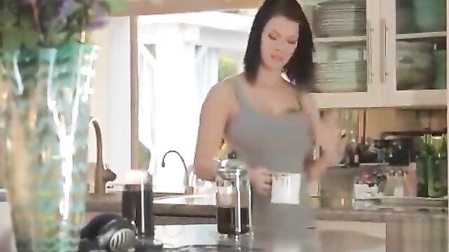 Peta Jensen in tight tank top brewing coffee in kitchen