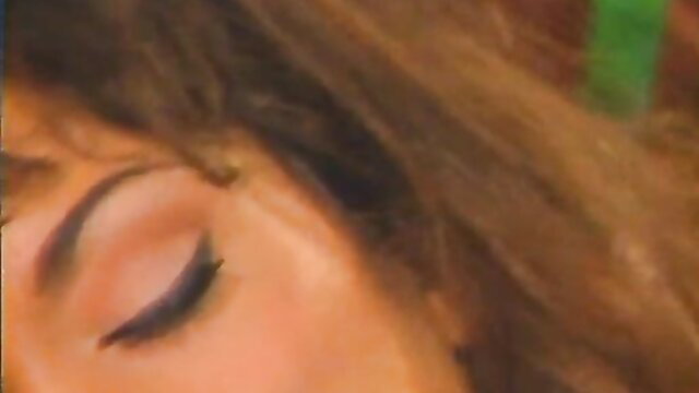 Closeup of seductive ebony woman's eye and thick wavy brown hair