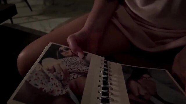 Hot MILF in pink lingerie flipping through nude photo album closeup