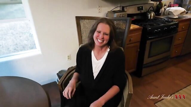 Smiling horny amateur MILF Aunt Judy in kitchen chair