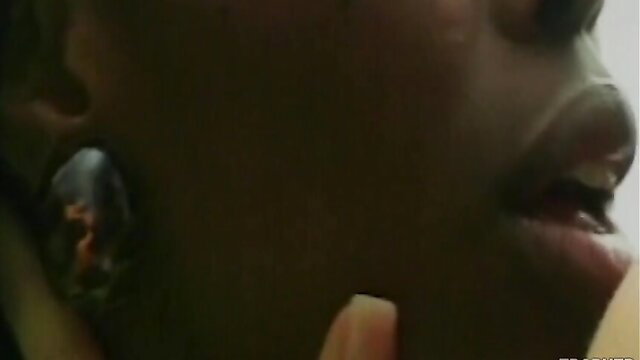 Closeup of black petite girl's glossy lips and tongue in lesbian tease