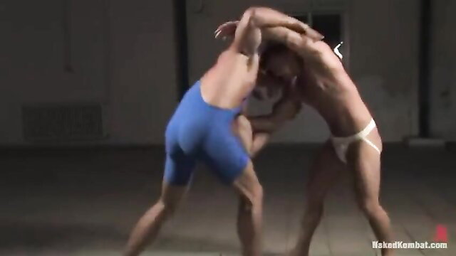 Muscular teen wrestlers grappling in singlets, intense homoerotic hold
