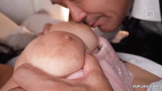 Asian babe's huge natural tits squeezed and kissed up close in JAV scene