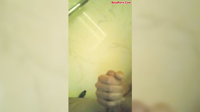 Amateur guy jerking off under steamy shower closeup