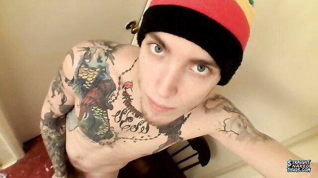 Tattooed twink with dreads in rasta beanie poses nude solo