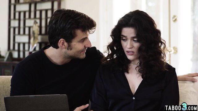 Curvy brunette babe whispers to handsome IT guy on couch