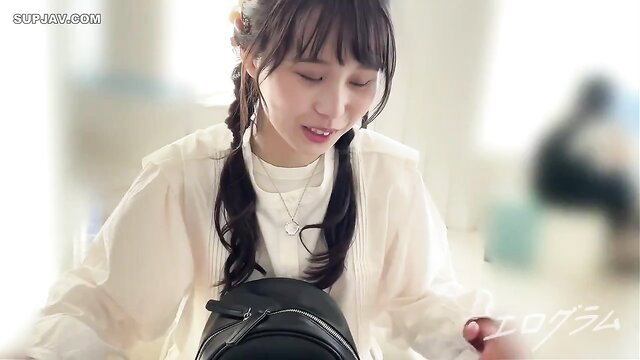Cute Japanese JAV girl with bangs and pigtails smiling softly in white blouse