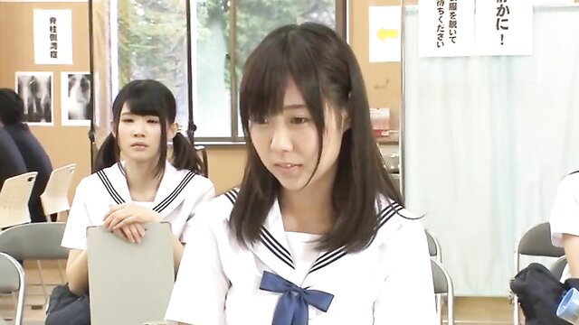 Japanese schoolgirls in sailor uniforms at health exam checkup