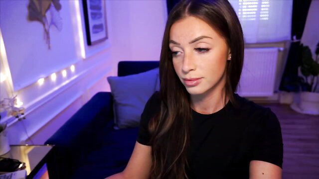 Emma Ruby hot brunette in tight black top, seductive gaze closeup