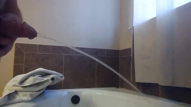 Man sounding cock with tube while pissing in bathroom sink HD